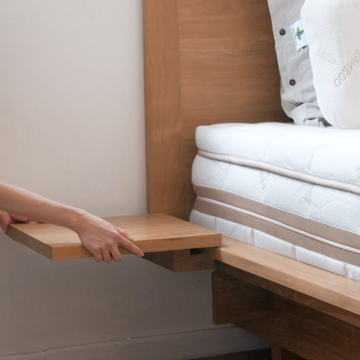Bed with cheap bedside tables attached